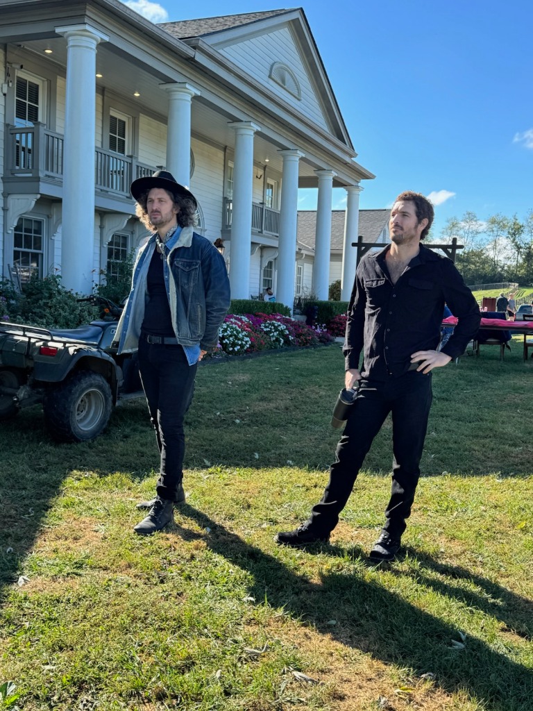 Jeffrey and Justice Joslin standing before Queenslake Manor on festival morning