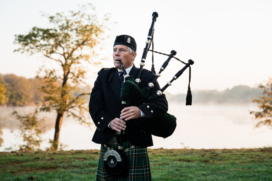Bagpiper Tore DeRolf playing in the morning mist at Queenslake